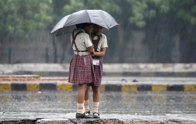 季雨中相拥在伞下的新德里女孩